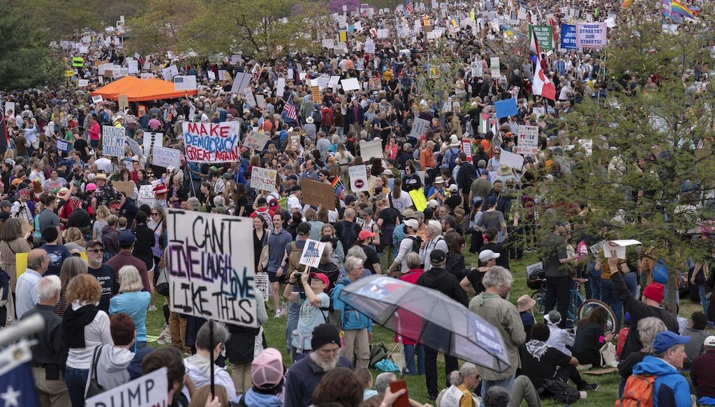 Demonstrators hold up banners during a 'Hands Off!' protest against President Donald Trump at the Washington Monument in Washington, April 5, 2025. (AP)