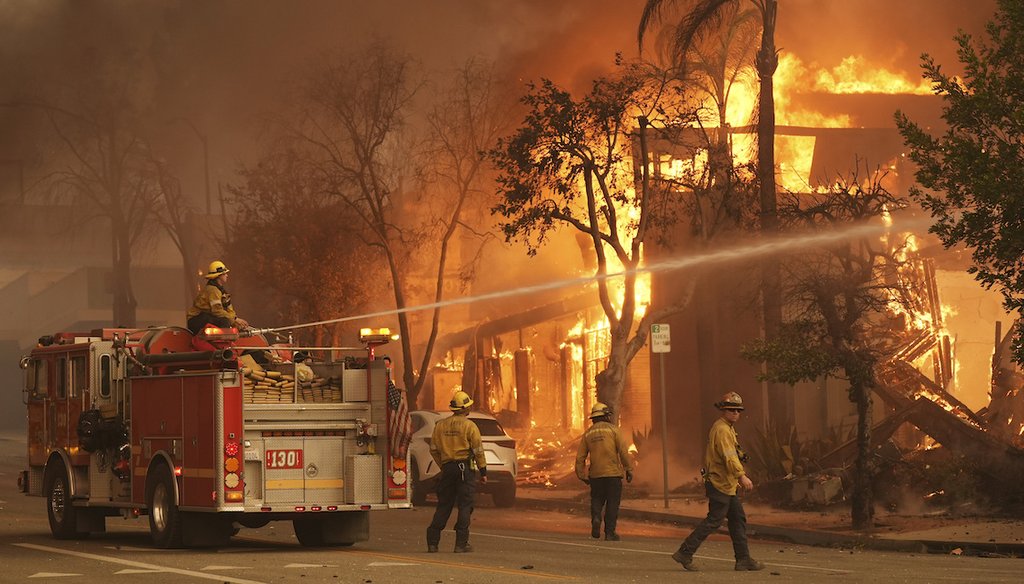Firefighters hose down a burning structure on Lake Avenue Jan. 8, 2025, in the downtown Altadena section of Pasadena, Calif. (AP)